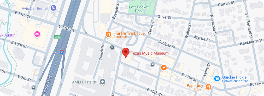 A map of the area surrounding the Texas Music Museum in Austin, Texas. The museum is marked with a red location pin on E 11th Street, near intersections with Waller Street and Lydia Street. Nearby landmarks include Franklin Barbecue to the west, Lott Pocket Park to the north, and Quickie Pickie convenience store to the east. Major roads such as the I-35 highway and E 10th Street are visible, providing context to the location.