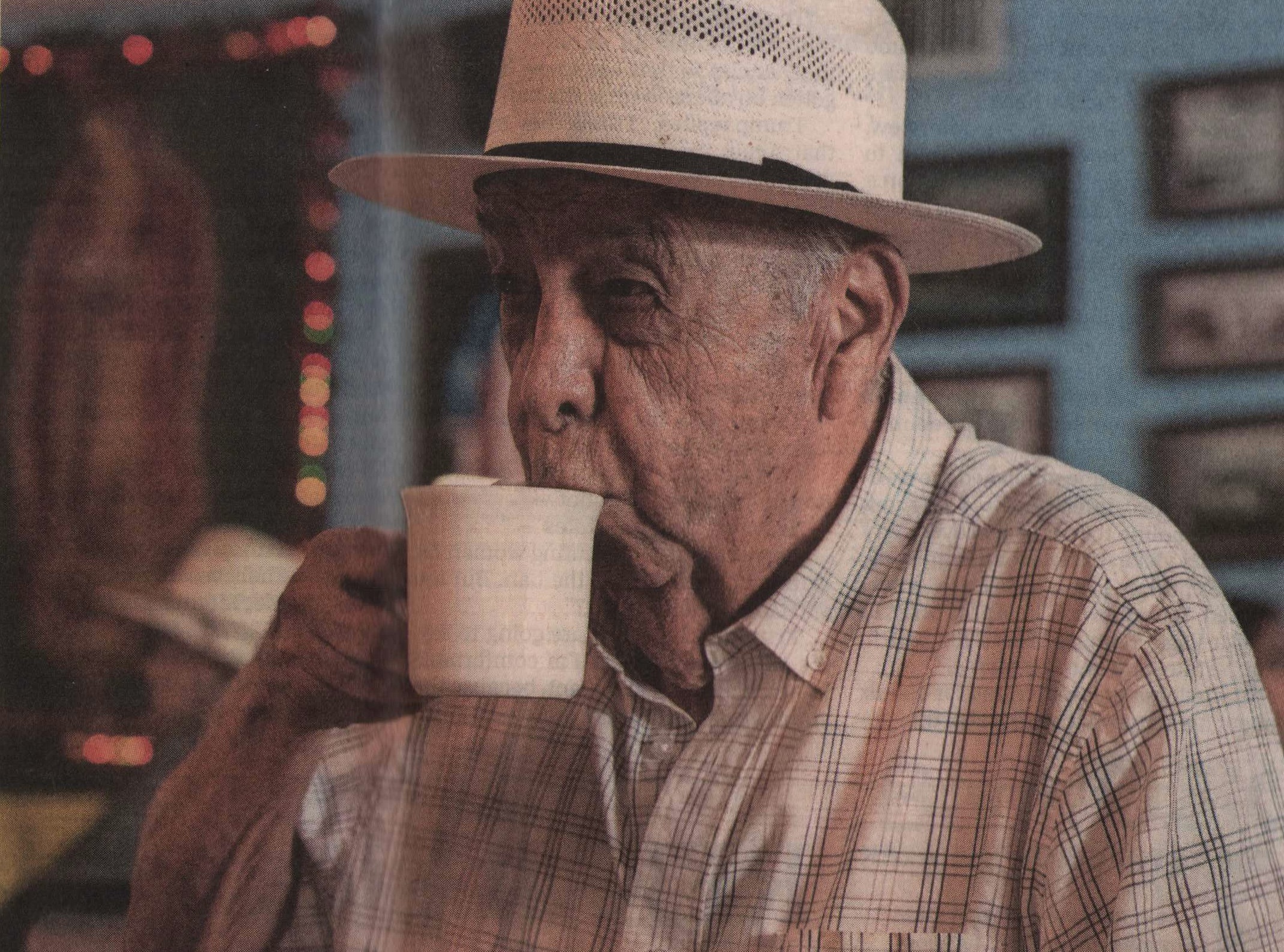 Johnny Degollado sipping coffee from a white mug at Joe's Bakery in Austin.